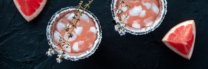 Salty Dog cocktail with fresh grapefruit juice, lime juice, and thyme panorama, a header for a menu