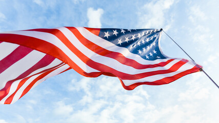 waving American flag against blue sky