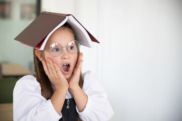 Surprised Girl with Book on Head