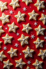 Festive star-shaped cookies on vibrant red background with snowflakes