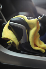 Staff use microfiber cloth to clean cars at car care shop.