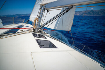 Sailing yacht moving at full speed with all sails up in the open sea near Croatia. Dynamic maritime adventure and freedom of ocean travel.