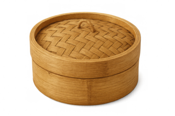 Bamboo steamer basket with lid, holding dumplings and vegetables, showcasing traditional asian cooking method on clean white backdrop