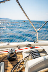 Close-up of rope clutches and winches on the deck of a sailing yacht near Croatia. Sailing equipment, control systems and technical detail of life at sea.