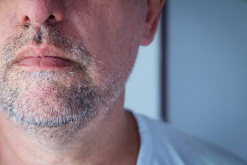 Close-Up of Mature Man’s Mouth and Chin with Stubble and Natural Skin Texture.
