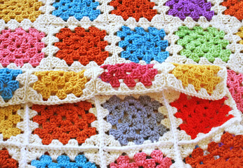 Handmade crocheted blanket using bright and colorful Granny squares