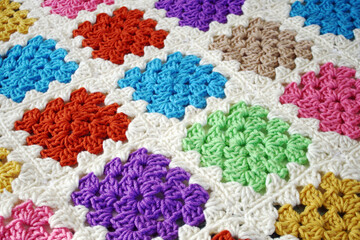 Handmade crocheted blanket using bright and colorful Granny squares
