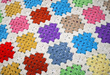 Handmade crocheted blanket using bright and colorful Granny squares