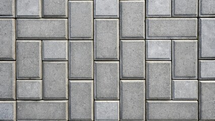 Fototapeta premium Textured Gray Paving Stone Pattern A Detailed Close-Up View of Interlocking Rectangular Blocks