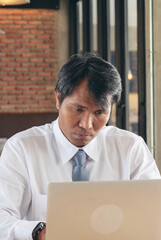 Vertical Horizon Asian Businessman stress working at home office using computer laptop online...