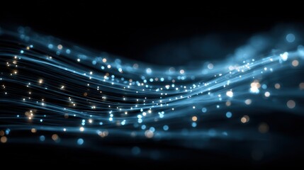 Abstract flowing blue and gold light trails against a dark background, suggesting energy and movement