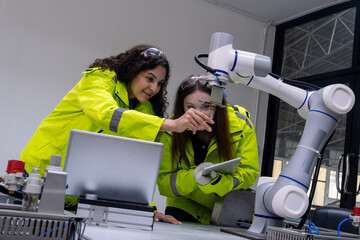 Engineers collaborate on robotics project in high-tech laboratory during bright daylight hours