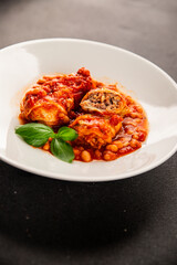 Stuffed cabbage tomato sauce with beans meat, cabbage, fresh delicious gourmet food background on the table rustic food top view copy space