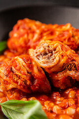 Stuffed cabbage tomato sauce with beans meat, cabbage, fresh delicious gourmet food background on the table rustic food top view copy space