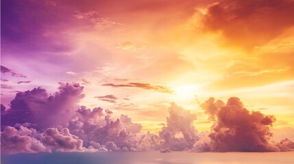 Fototapeta premium Dramatic sunrise with gradient orange and purple clouds, creating a panoramic abstract sky view.