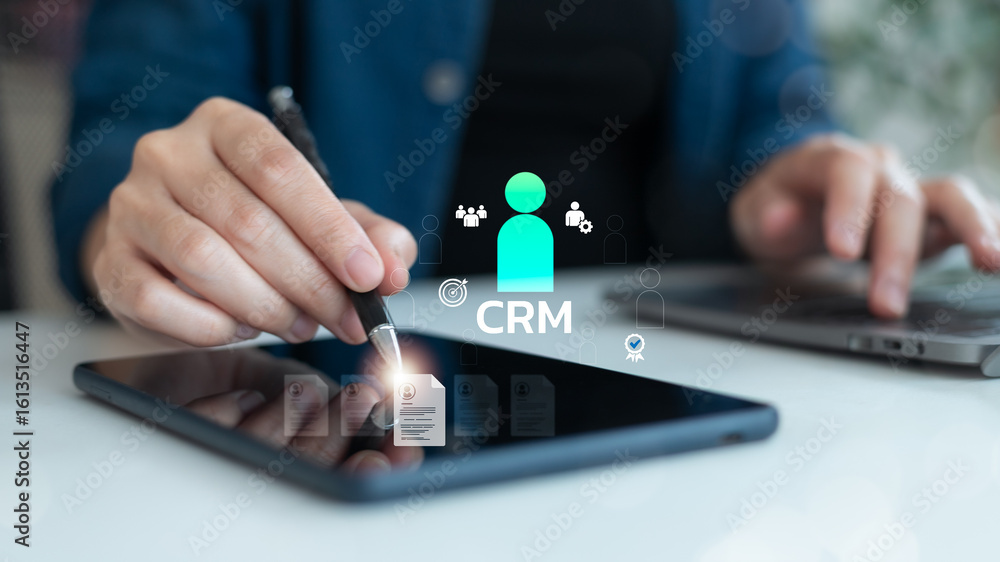 Poster close-up of a business hand using a digital tablet with crm interface, symbolizing customer relation
