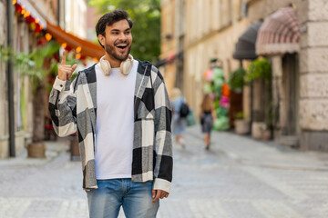 Eureka. Thoughtful clever inspired Indian man make gesture raises finger came up with creative plan feels excited with good idea inspiration motivation, question standing in city street. Lifestyles.