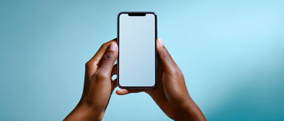 The smartphone held in hands against a stylish blue background.