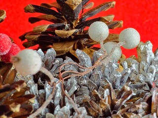 New Year's set for creativity. Natural painted cones and white rowan in glaze. Close-up. Red...