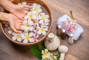 Spa Hand Soak, Relaxing foot spa treatment with herbal compresses, oils, and frangipani flowers in...