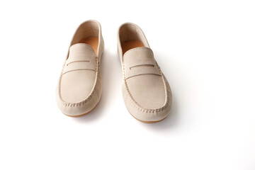 Pair of beige suede penny loafers photographed on white background. Studio product photo. Casual footwear concept. Design for banner, poster, card, header. Perspective view with copy space