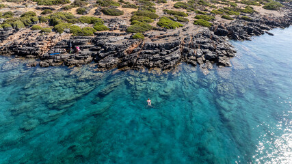 panoramic drone view of coastal sea water and rocky shore near Crete island