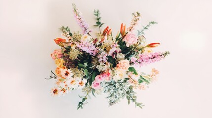 Vibrant floral arrangement captured from above on a clean white surface.