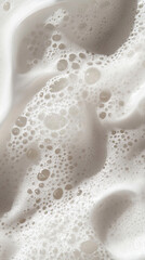 Soft textured foam from cleanser on shiny surface with pastel lighting