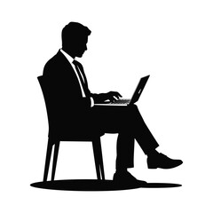Silhouette of a businessman sitting and working on a laptop