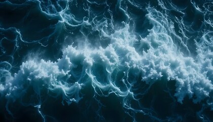 Aerial shot capturing a vast, foamy ocean wave cresting and breaking with churning patterns
