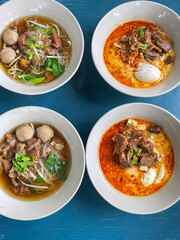 A photography of a bowl of soup with eggs and meat. The closed up of Thai noodles with meat ball. 