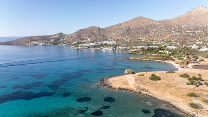 panoramic drone view of ancient mills and canal with bridge near crete island