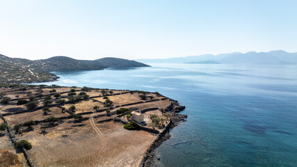panoramic drone view of ancient mills and canal with bridge near crete island