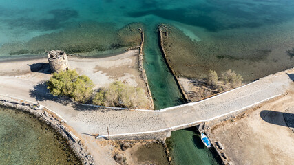 panoramic drone view of ancient mills and canal with bridge near crete island