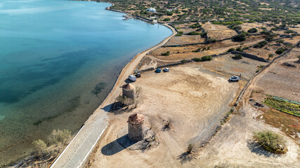 panoramic drone view of ancient mills and canal with bridge near crete island