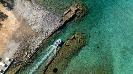 panoramic drone view of ancient mills and canal with bridge near crete island