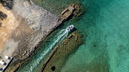 panoramic drone view of ancient mills and canal with bridge near crete island
