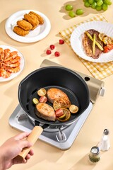 Delicious Salmon and Vegetable Stir-fry in a Non-Stick Pan on a Modern Stovetop, Frying pan with salmon filet and vegetables on beige background