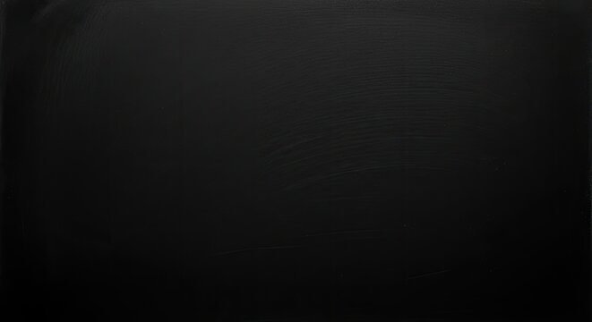 Blank blackboard surface with faint chalk dust streaks, perfect for educational or creative backgrounds