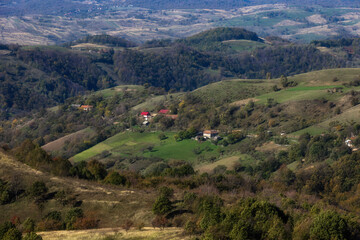 Panoramic Mountain Landscape: Lush Green Hills, Forests, and Valleys Under a Clear Summer Sky