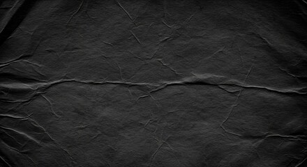 Discover the rich texture of crumpled black paper, offering a sophisticated, tactile background for your creative projects and design needs.