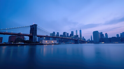 Stunning view of city skyline at dusk, featuring bridge and reflective water, creating serene atmosphere
