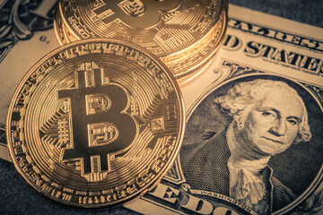 Bitcoin and dollar banknotes. Cryptocurrency concept. Selective focus. Toned.
