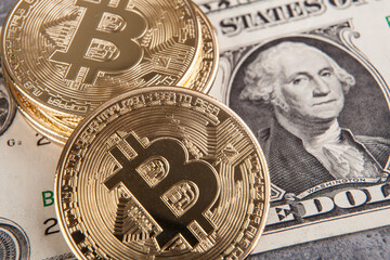 Bitcoin and dollar banknotes. Cryptocurrency concept. Selective focus. Toned.
