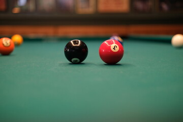 Billiard cues on a pool table