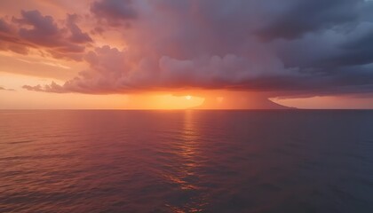 Obraz premium Dramatic sunset over calm ocean with storm clouds gathering, illuminating the horizon