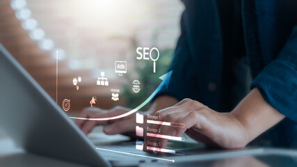 Close-up of hands typing on laptop with SEO icons and upward arrow, representing digital marketing,...