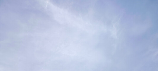 Background with clouds on blue sky. Sky view. Beautiful sunny sky. Clouds on blue sky. Sun shining through the puffy clouds.