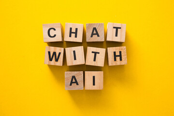 Wooden cubes showing chat with ai on yellow background