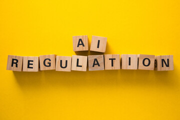Ai regulation concept with wooden cubes on yellow background
